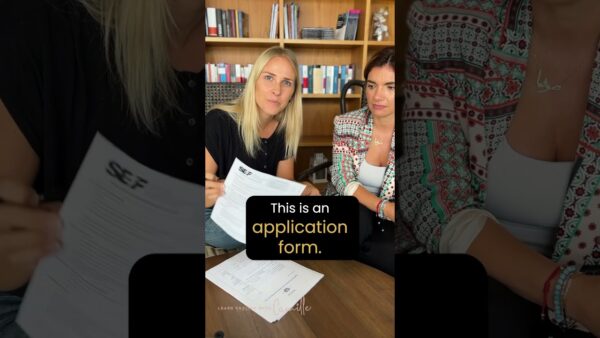 Two people sitting at a table with documents labeled SEF. Bookshelf in the background. Text says, "This is an application form."