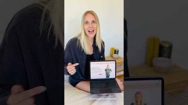 Camille sitting indoors, holding a laptop displaying an English learning webpage, with decorative items on a wooden table in the background. Video of 5 ways we use RUN in English