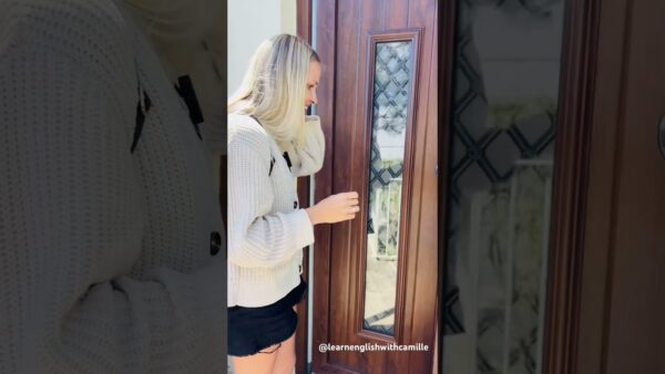 A person in a white sweater stands at a wooden door, with decorative glass panels. The Instagram handle is visible.