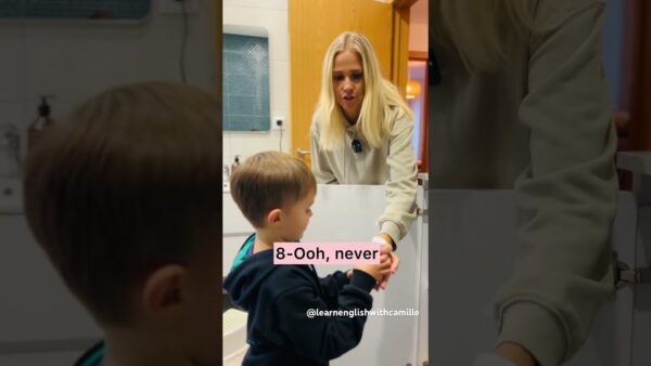 A person guides a child washing hands at a sink. Text reads “8- Ooh, never” with handle “@learnenglishwithcamille.”