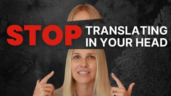 A person points to their head, with bold text saying “STOP TRANSLATING IN YOUR HEAD” on a textured dark background.